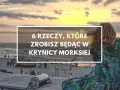 Zachód słońca nad morzem, kobieta w sukience w liście. Czy warto jechać do Krynicy Morskiej? 6 rzeczy, które zrobisz będąc tam.