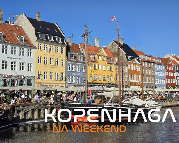 Kolorowe kamienice nad kanałem, żaglowce i ludzie odpoczywający w kawiarniach. Idealne miejsce na **Kopenhagę na weekend**.